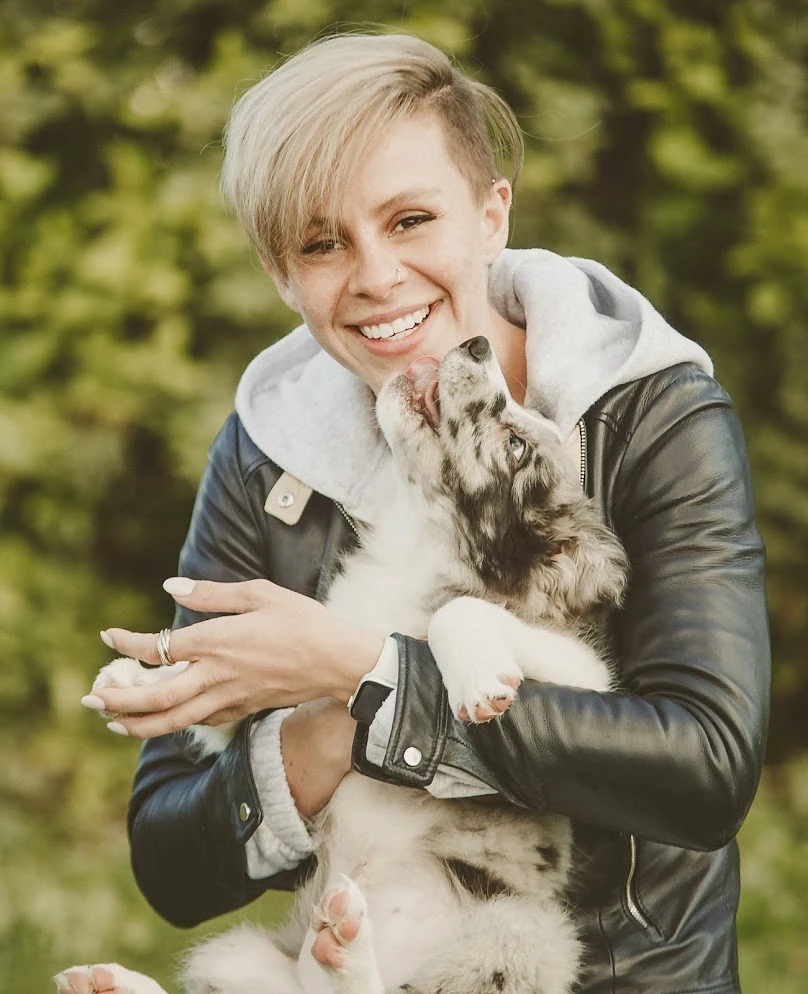 Laura holding a dog